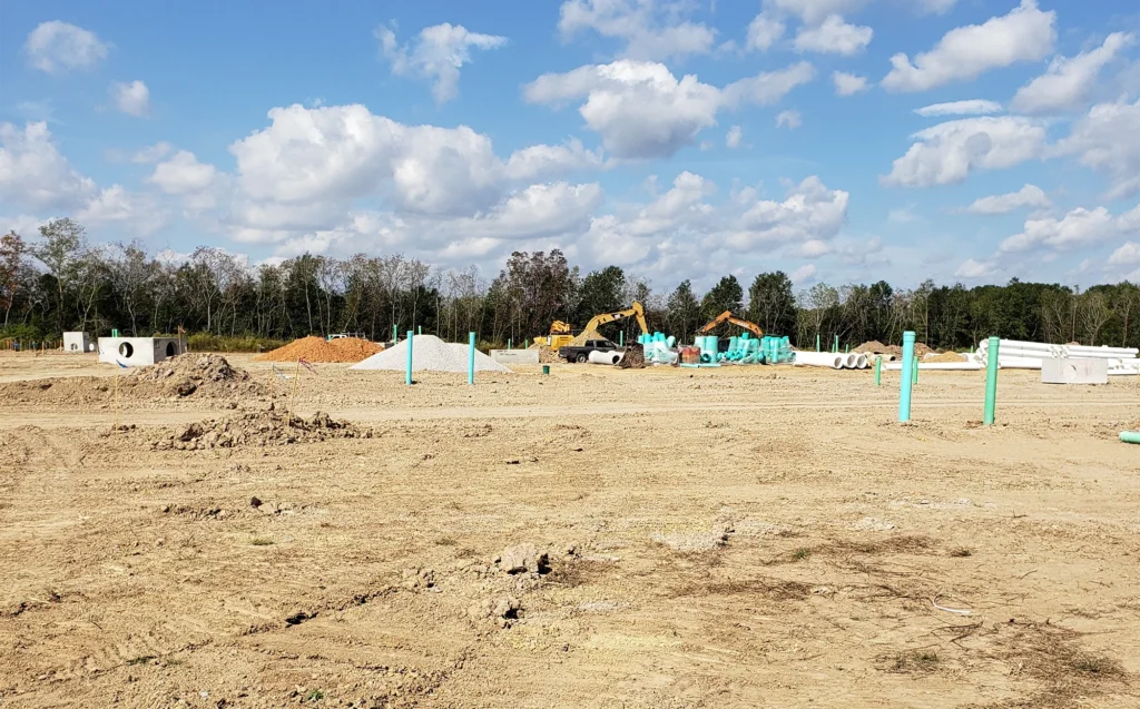 excavators-on-field-with-concrete-block-and-pipes