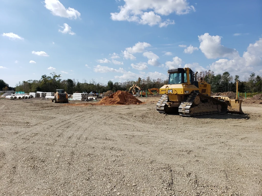 bulldozer-on-field-with-white-pipes