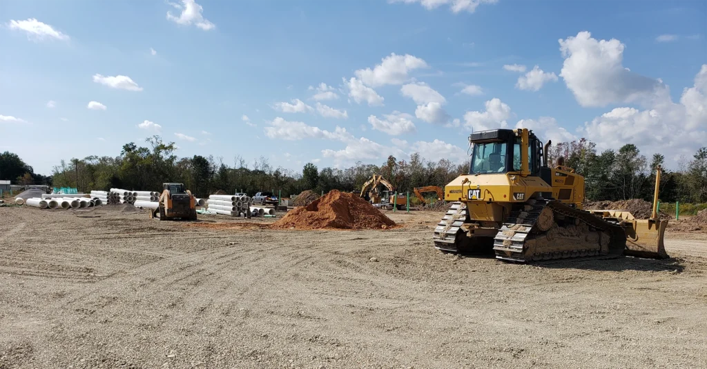 bulldozer-on-field-with-white-pipes