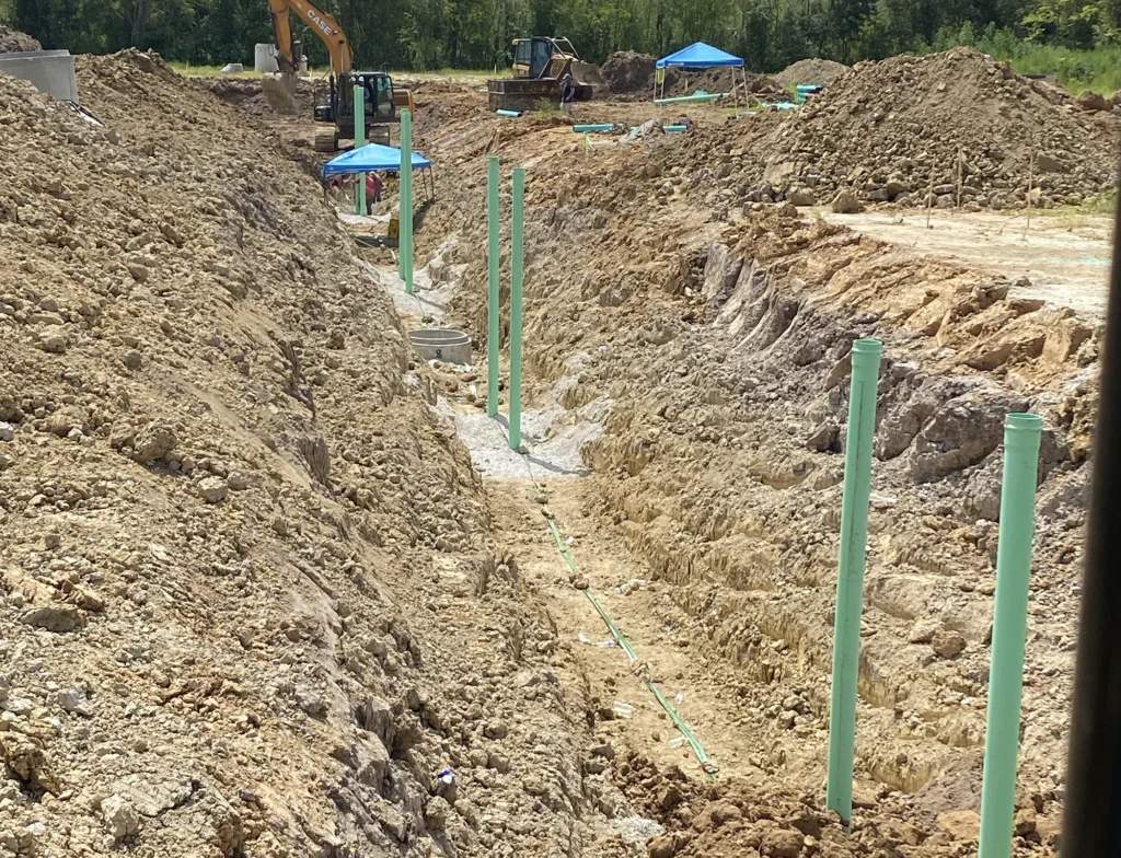 excavator-green-pipe-on-soil