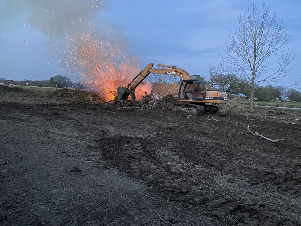 excavator-with-branches-on-fire