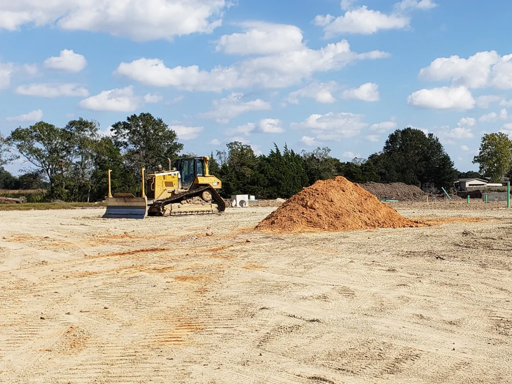 bulldozer-on-field-with-sands