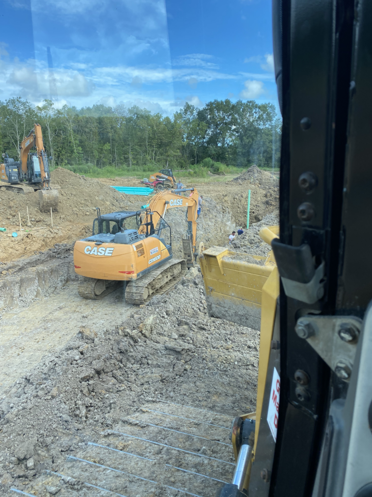 window-view-excavator-digging-straight